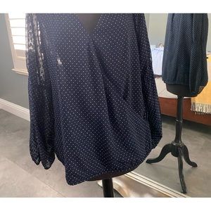 Dark blue blouse with polka dots.